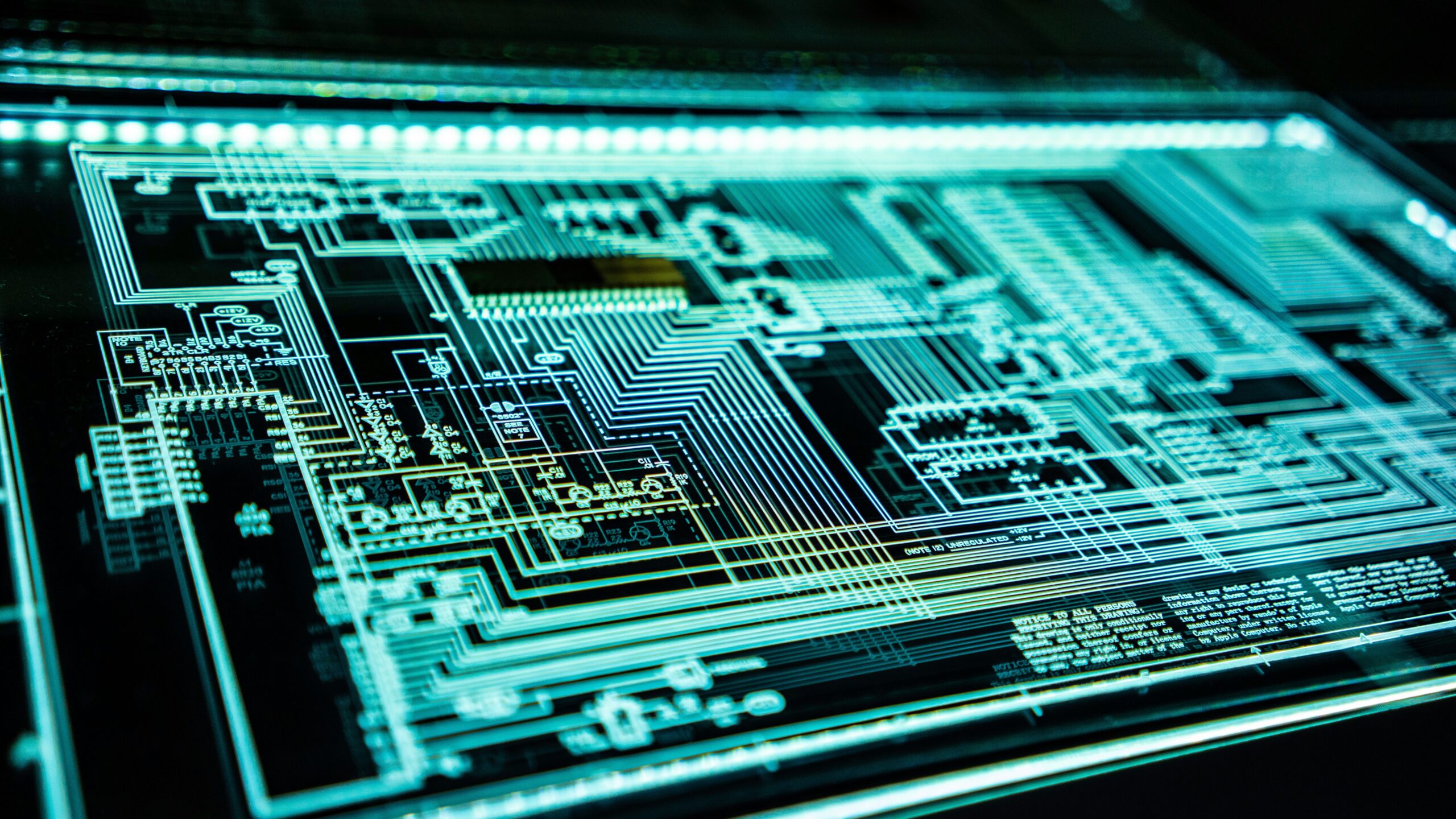 Close-up of a digital circuit board with glowing lines representing data flow and cybersecurity infrastructure, illustrating the concept of why invest in managed security.