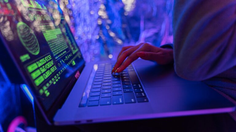 Person using black laptop computer, illustrating the core advantages MSSP services provide in proactive cybersecurity management.