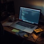 Laptop with code on desk showing protecting websites owasp top 10 implementation in development environment